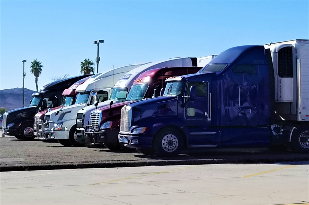 Charting the Course: A Deep Dive Into the Auto Tech Odyssey of 2024 3 trucking big rigs all in a row 2023 11 27 05 31 14 utc
